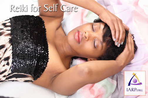 A woman practicing Reiki for Self Care